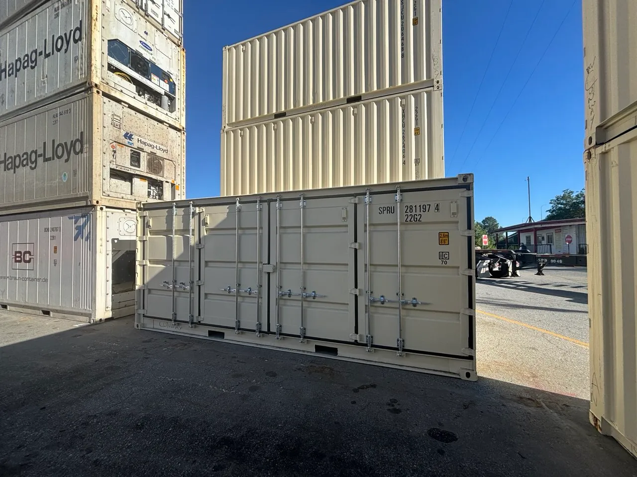 Clean tan 20ft shipping container, side profile in the yard